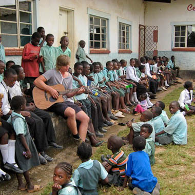 Volunteer Thomas Duxfield with children